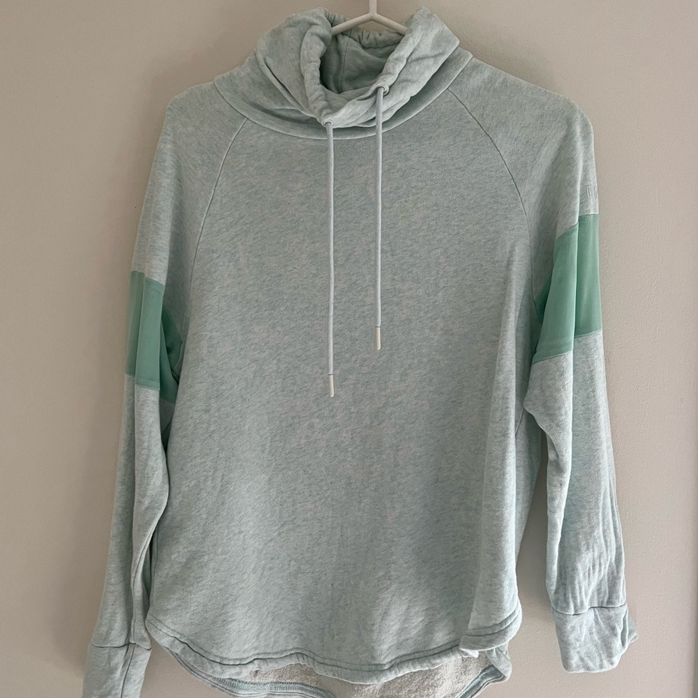 Light green xs gymshark pullover with mesh detailing and curved hem